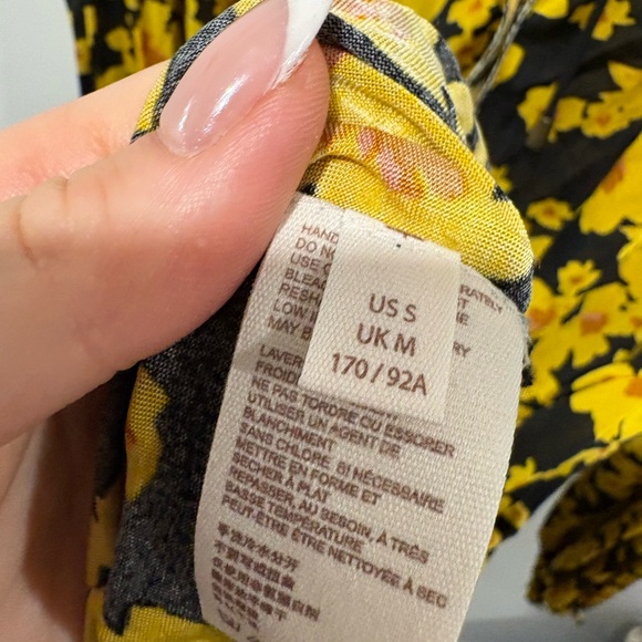 Free People Love Letter Floral Tunic Blouse in a black and yellow floral print. - Picture 10 of 11